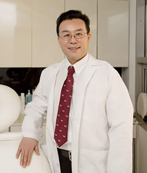 Dr. Huachen Wei standing in a DR WW Dermatology treatment room in New York